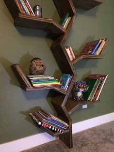 a book shelf with books on it in the corner of a room next to a wall