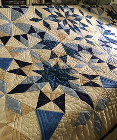 a quilted bed with blue and white stars on it