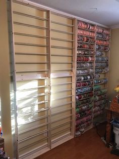 a room filled with lots of different types of items on shelves next to a window