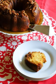 a bundt cake sitting on top of a white plate next to a cupcake