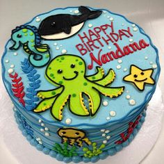 a birthday cake decorated with an octopus and whale