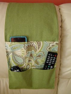 there is a cell phone and remote control in the pocket on this couch, along with other items