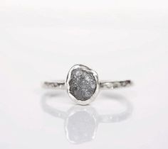 a white gold ring with grey druzby stone