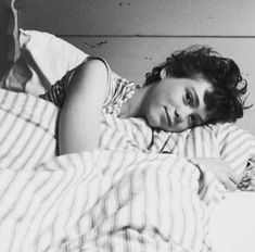 black and white photograph of a woman laying in bed