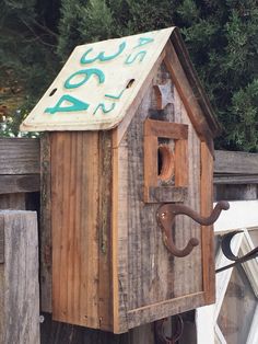 a wooden birdhouse with the word boo written on it's roof and door