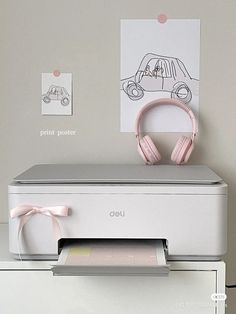 a printer with headphones on top of it