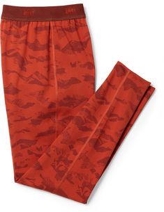 a pair of red pants with dinosaurs printed on them, sitting next to each other