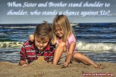 two children are playing in the sand at the beach with their arms around each other