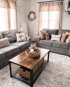 a living room with two couches and a coffee table in front of the window