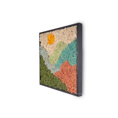 an abstract painting on the wall with multicolored rocks and gravel in front of it