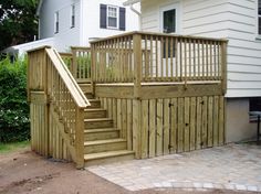 a wooden deck with steps leading up to a house