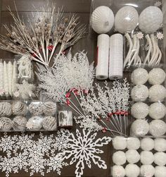 white christmas decorations and candles are on display