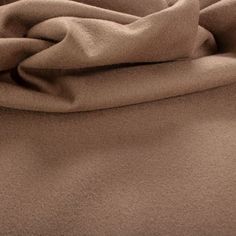 a close up view of a bed with brown sheets