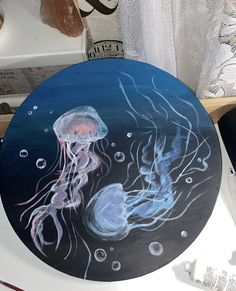 a painting of two jellyfish on a table