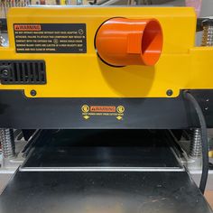 a machine that is sitting on top of a metal table with an orange object in the middle