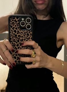 a woman holding up her cell phone case with rings on the front and bottom cover