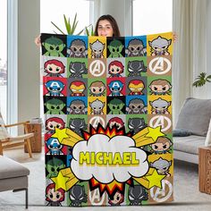 a woman is holding up a blanket with the name michael in front of her face