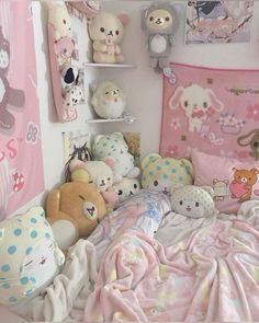 there are many stuffed animals on the wall above the bed and in the corner is a teddy bear