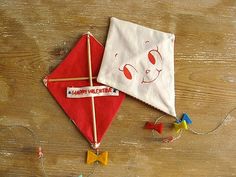 two kites are sitting on a wooden table