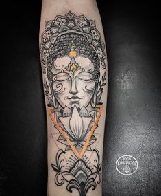 a woman's face with an orange arrow in her hand on the forearm and behind it is a black and white tattoo design