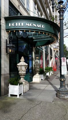 the hotel monaco is located on the corner of an old - fashioned street lamp post