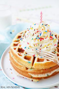 a waffle topped with whipped cream and sprinkles