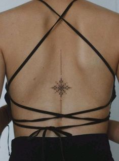 the back of a woman's bra with an intricate tattoo