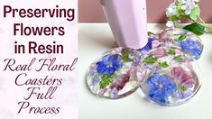 there are flowers in resin - printed coasters next to the hairdryer and blow dryer