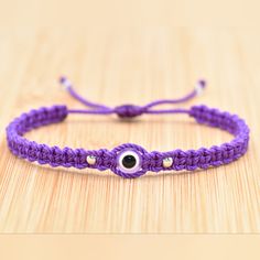 Fashionable And Durable Hand-Made Purple String Bracelet With An Evil Eye Charm For Wrist Sizes From 6 To 9 Inches. With An Easy To Use Zip Like Function To Fit Your Wrist, You'll Have It On As Soon As You Get It. Made From High-Quality Purple String, It Will Be Sure To Last. Wearing An Evil Eye As An Amulet Is Believed To Provide Protection Against Evil Forces. The Evil Eye Meaning Has Symbolism In Almost Every Country In The World And In Every Religion. Each Bracelet Is Carefully Handcrafted A Evil Eye Meaning, Protection Against Evil, Eye Meaning, Bracelet Evil Eye, Purple Bracelet, Eye Bracelet, String Bracelet, Evil Eye Charm, Evil Eye Bracelet