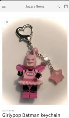 a pink lego batman keychain with a heart on the front and star on the back