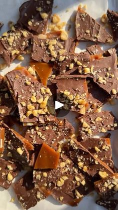 pieces of chocolate and nuts on a white plate