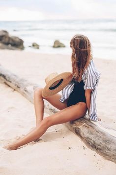 Jess Ann Kirby wearing a striped button down and black one piece