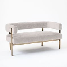 a white couch sitting on top of a wooden frame