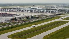 an aerial view of the airport with planes parked on the tarmac and in the background