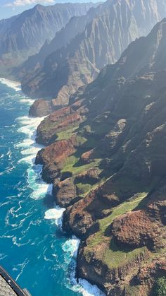 an aerial view of the ocean and mountains