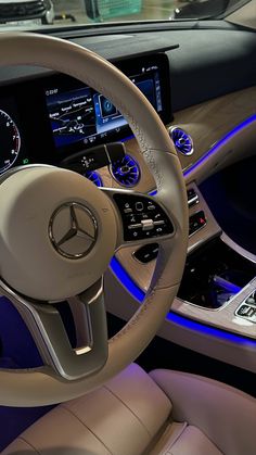 the steering wheel and dashboard of a mercedes benz - benz s - class sedan at night