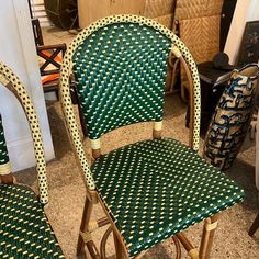 two green and yellow chairs sitting next to each other on top of a carpeted floor