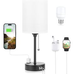 there is a phone charging next to a lamp and an iphone on the charger