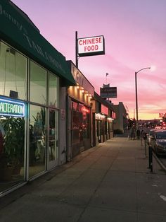 a chinese food restaurant is lit up at dusk