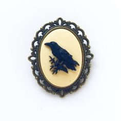 Raven Brooch Crow Pin Cameo Bird Jewelry Renaissance Faire Costume Pirate Edgar Allan Poe Gift-I make this brooch using a black and deep cream raven cameo and set it in an antique brass setting with a C clasp-Measures 1 1/4" x 1 1/2"-Gift BoxedMore of my Raven Jewelry:https://www.etsy.com/shop/lydiasvintage/items?ref=pagination&search_query=ravenIf you need more jewelry, please let me know- I have bracelets, anklets, charms, necklaces, keychains, rings, brooches, all kinds of stuff. I love c Raven Jewelry, Crow Bird, Pirate Hats, Cameo Jewelry, Pirate Costume, Edgar Allan, Cameo Brooch, Bird Brooch, Bird Jewelry