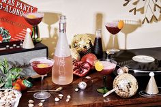 various cocktails are sitting on a table next to an old record player and disco ball