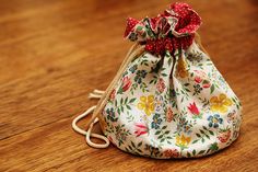 a drawstring bag sitting on top of a wooden table