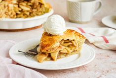 a slice of apple pie on a plate with a scoop of ice cream