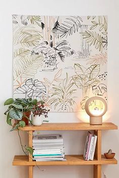 a wooden shelf with books and plants on it