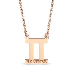 a gold necklace with the letter i on it's front and back sides,