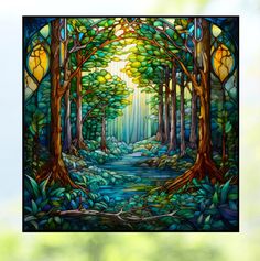 a stained glass window with trees and water