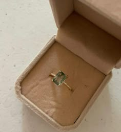 an open box with a ring in it