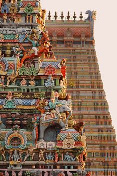 an elaborately decorated tower with statues on it's sides