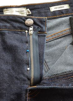 a pair of jeans with an open zipper