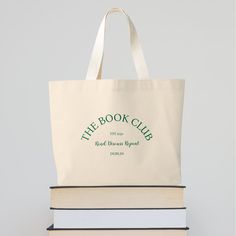 two books stacked on top of each other with the book club logo printed on them